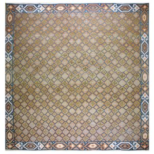 Low-pile rug with a rust, blue, and green geometric diamond lattice featuring central swirling motifs.