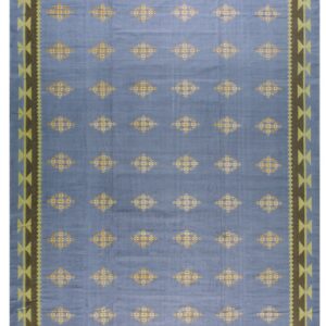 Light blue rug featuring repeated yellow geometric diamonds and a wide brown and lime-green patterned border.