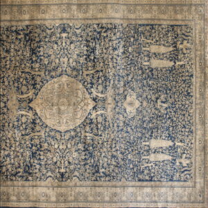Traditional rug with a navy and cream floral pattern, featuring birds and a large central medallion.