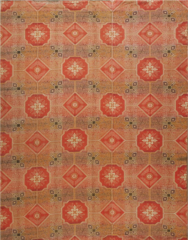 A repeating geometric pattern of red octagons and gold diamonds against a faded orange and brown field.