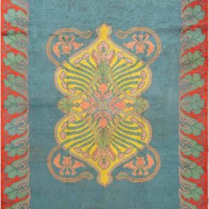 Teal area rug with a yellow and pink central design surrounded by a wide coral and green border.