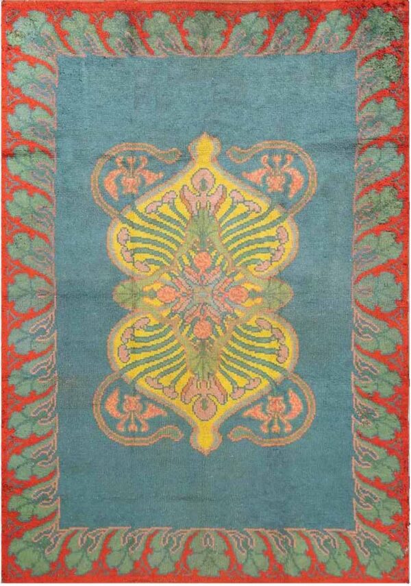 Teal area rug with a yellow and pink central design surrounded by a wide coral and green border.