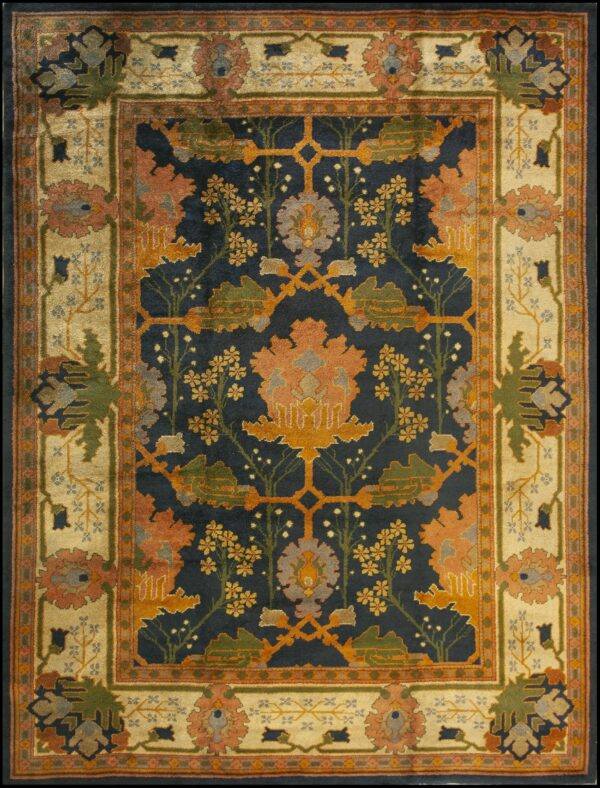 Navy, rust, and gold patterned rug featuring a stylized floral tree design and a wide cream border.