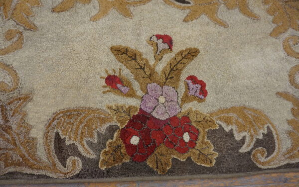The high-pile rug has a bouquet design of red and lavender flowers framed by brown scrolling leaves.