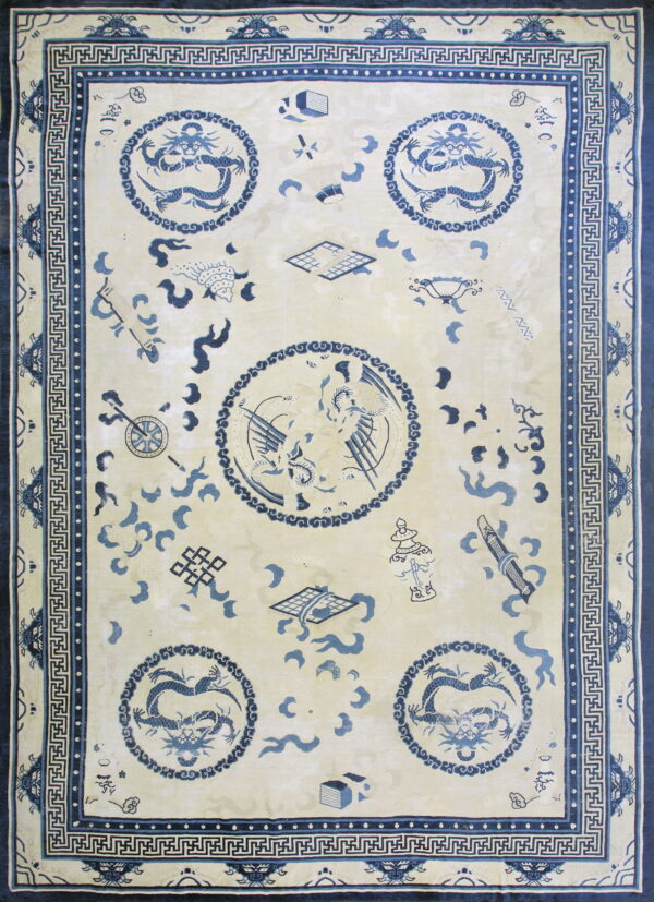 Cream and blue rug with dragon and bird medallions, scattered symbols, and a complex key-pattern border.