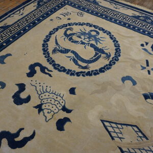 Beige rug featuring a detailed blue dragon medallion, scattered symbols, and geometric borders on wood flooring.