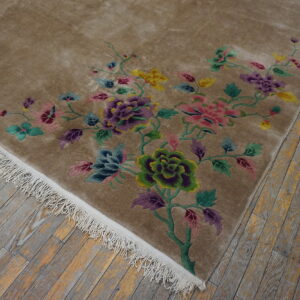 Beige plush rug with vivid purple, pink, green, and yellow floral patterns on weathered wood planks.