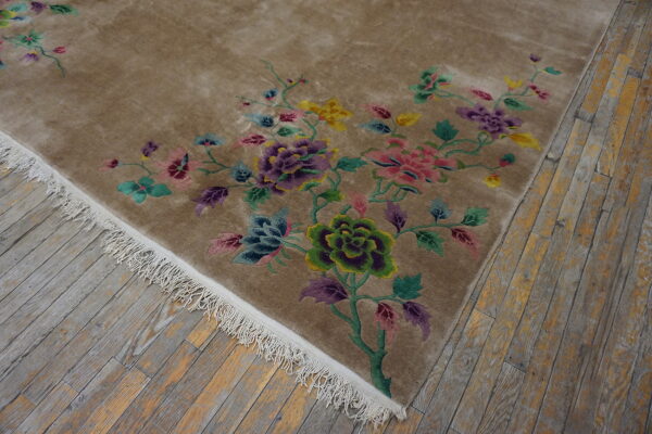 Beige plush rug with vivid purple, pink, green, and yellow floral patterns on weathered wood planks.