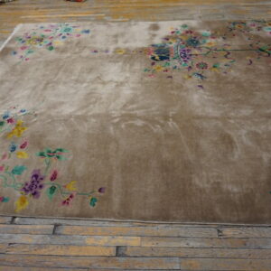 Shimmering taupe rug with bright floral vine borders lies on rustic wooden flooring.