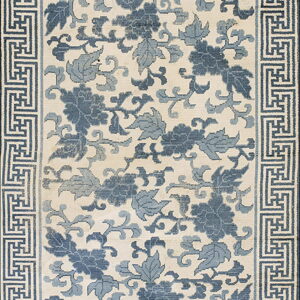 Cream rug with deep and light blue floral designs surrounded by a geometric key border.