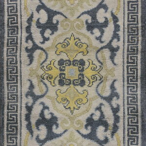 Cream runner rug with gray Greek key border and stylized blue and yellow central scrollwork patterns.
