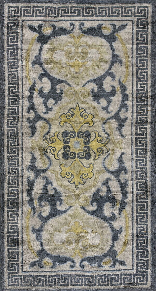 Cream runner rug with gray greek key border and stylized blue and yellow central scrollwork patterns.