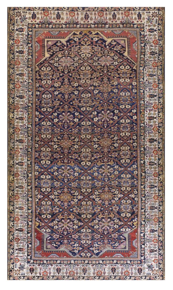 Dark navy rug with intricate red and ivory floral lattice patterns and a wide patterned cream border.