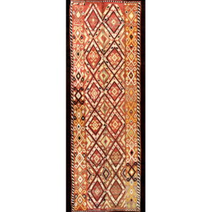 Flatweave runner featuring repeating diamonds and geometric motifs in shades of rust, gold, and cream.
