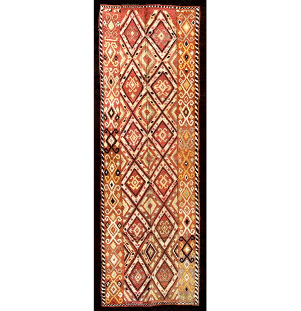 Flatweave runner featuring repeating diamonds and geometric motifs in shades of rust, gold, and cream.