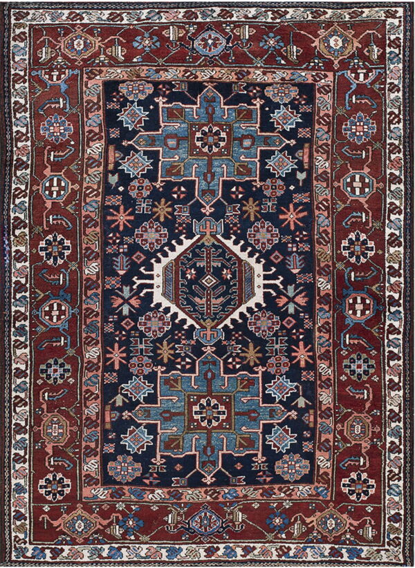 Navy blue rug with geometric medallions and stylized flowers on a dark red and light blue ground.