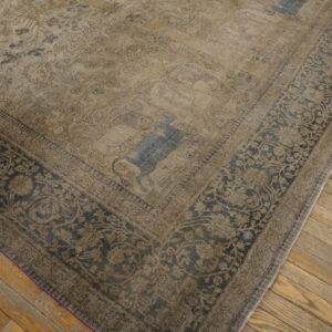 Distressed beige rug featuring faded blue animal motifs and a dark floral border on wooden floors.