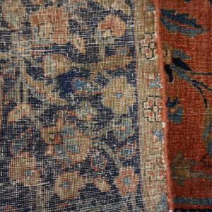 A close view shows a patterned low-pile structure next to a rust-red area with navy floral designs.