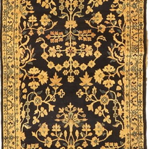 Narrow black runner rug displaying a detailed repeating golden floral and vine pattern with multiple borders.