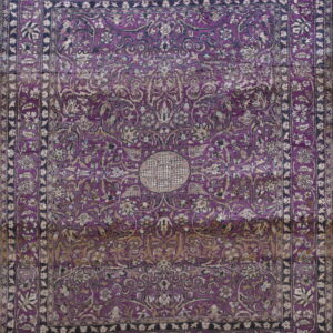 Low-pile rug in deep purple with dense tan and navy floral patterns and a central circular medallion.