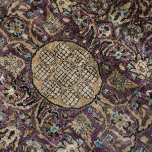 Velvety traditional rug close-up in purple, tan, and blue with an intricate central medallion design.