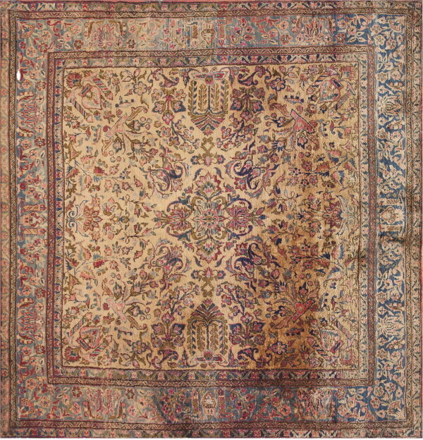 Beige square rug featuring dense pink and blue traditional floral patterns and a wide blue border.