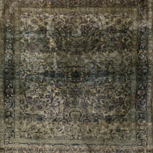 Distressed traditional rug featuring faded purple, dark green, and tan colors in an elaborate floral design.