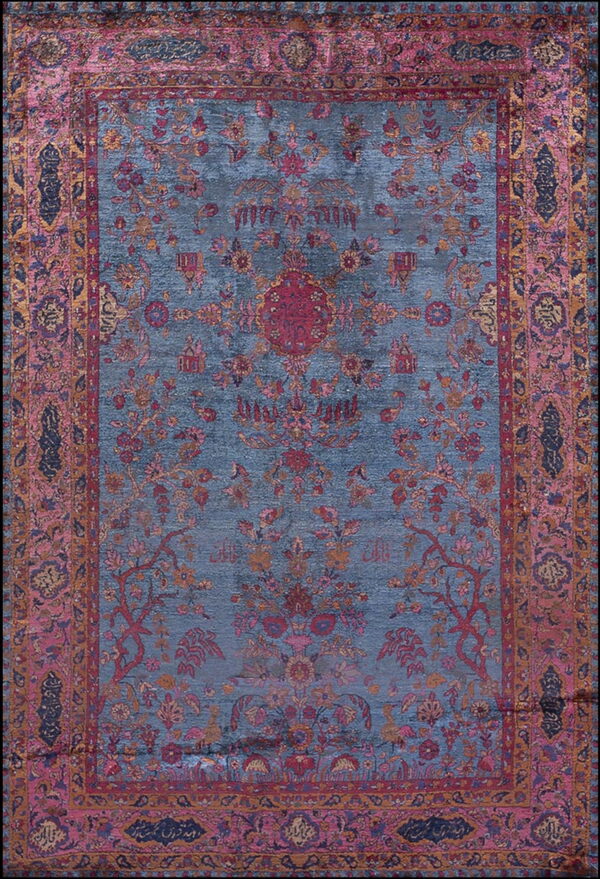 Slate blue rug with a complex traditional floral pattern outlined in pink, red, and gold.