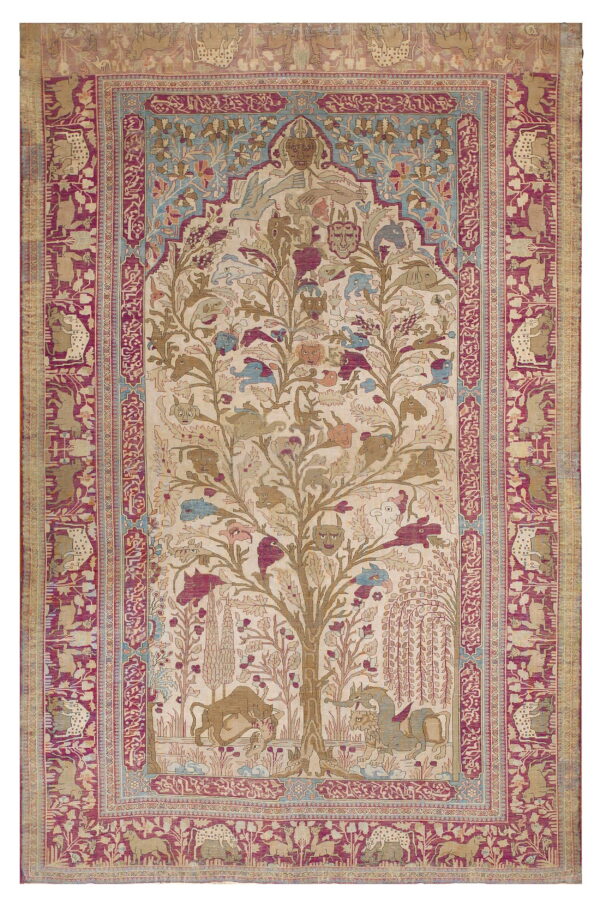 Antique-style rug with a central tree of life design featuring faces and animals on a cream field, bordered by raspberry and tan patterns.