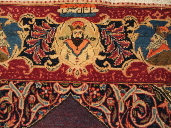 Ornate rug detail featuring a central portrait, red border, blue field, and complex floral patterns.