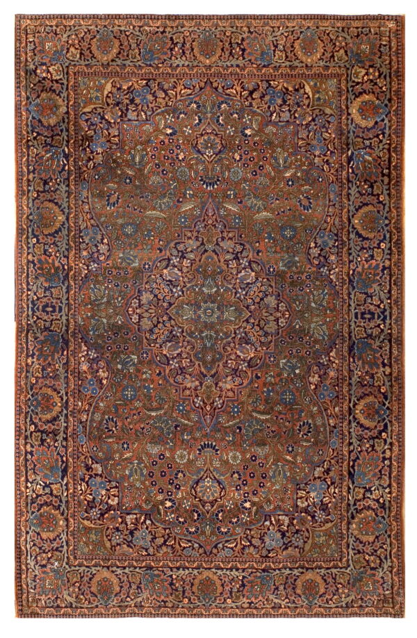 A traditional rug with a dense floral pattern and central medallion in rust, navy, blue, and green.