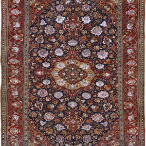 Detailed traditional rug featuring a dark blue field, an elaborate central medallion, and a wide rust red floral border.