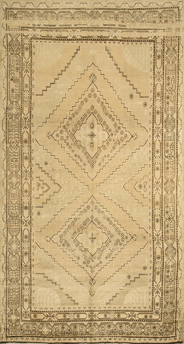 Monochromatic tan and beige rug with a large stepped central diamond and intricate geometric borders.