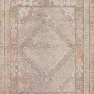 Muted rug with a central geometric diamond motif and layered borders in dusty gray, coral, and cream.