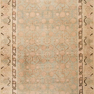 Low-pile rug with a pale blue geometric floral field and multi-banded beige and pink borders.