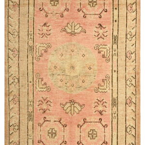 Pale pink and beige traditional rug with a central medallion and dark geometric borders.