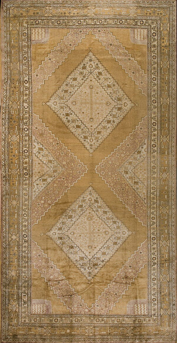 Golden brown rug with large central geometric diamond medallions and an ornate patterned border.