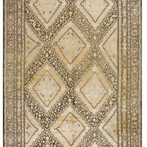 A rectangular rug with large interlocking geometric diamond patterns in light beige and dark brown.