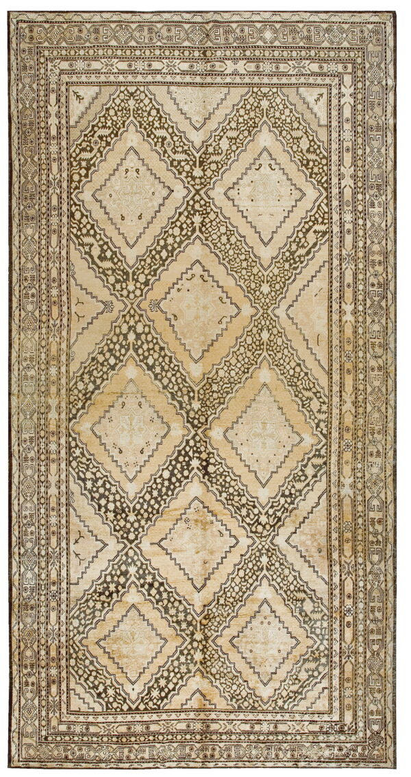 A rectangular rug with large interlocking geometric diamond patterns in light beige and dark brown.