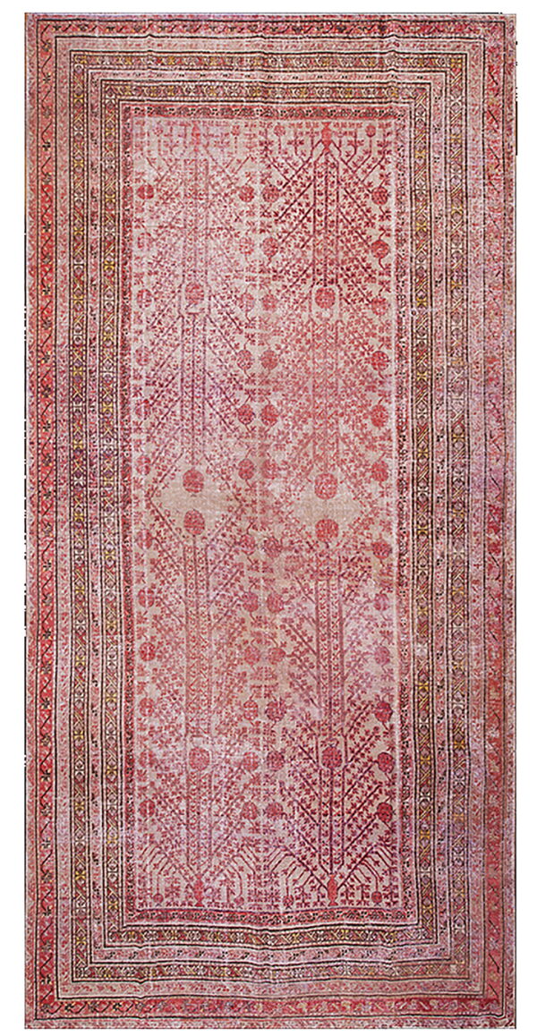 Muted red and beige rug displaying a detailed, repeating pattern of geometric and stylized tree motifs.