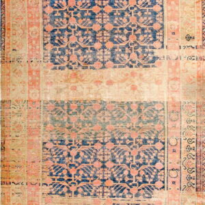 Worn, low-pile rug with navy and faded pink geometric medallions separated by wide beige bands.