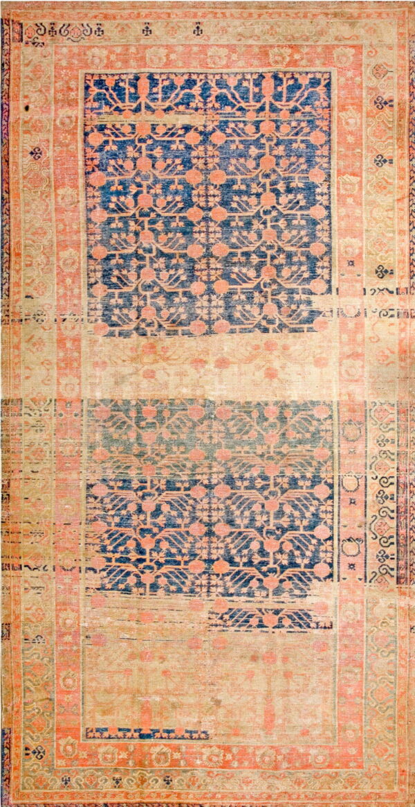 Worn, low-pile rug with navy and faded pink geometric medallions separated by wide beige bands.