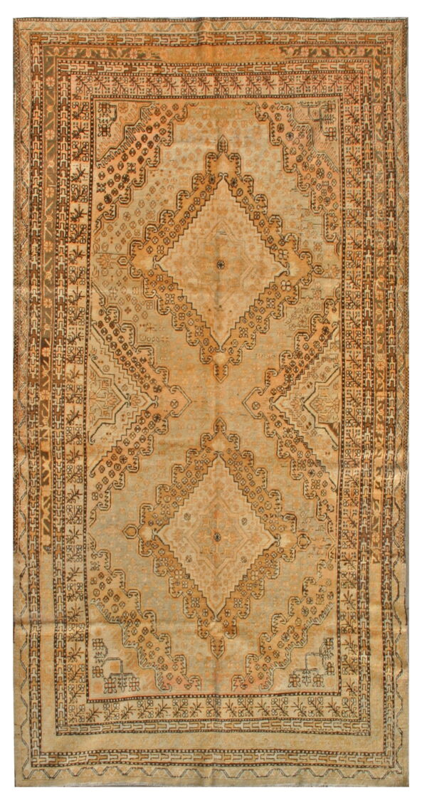 Geometric rug with large diamond medallions and detailed borders in faded ochre, brown, and pale gray.