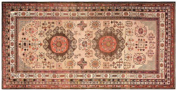 Rectangular rug featuring a soft beige field, two brown medallions, and geometric tribal motifs in red and dark colors.