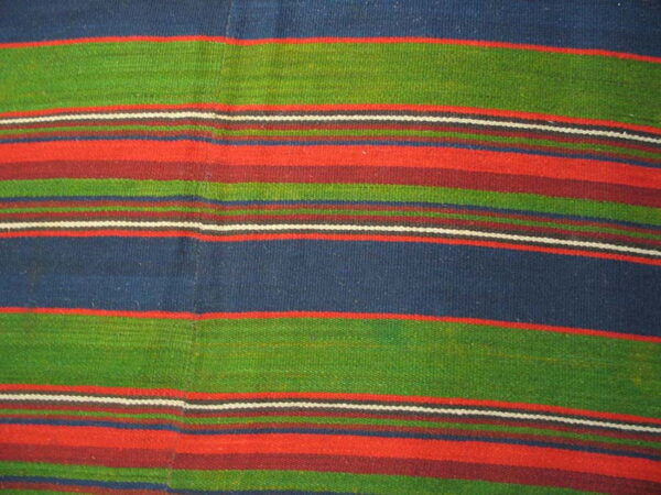 Boldly striped flat-weave textile in wide bands of blue, green, red, burgundy, and thin white lines.