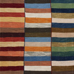 Three stitched vertical panels form a flatweave rug patterned with multi-colored horizontal stripes.