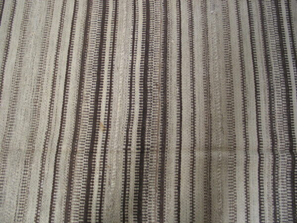 Flat-woven textile features vertical stripes in alternating natural light and dark brown tones.