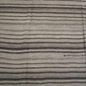 Textured rug featuring wide pale gray bands alternating with narrow dark brown geometric striped patterns.