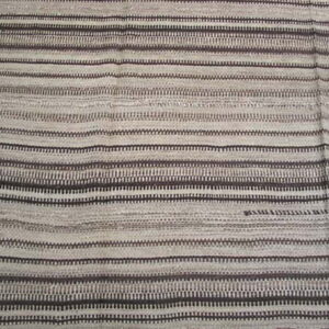Flatweave rug with horizontal stripes composed of dashed dark brown and light natural tone lines.