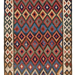 Geometric rug with dense, colorful diamond and cross motifs bordered by patterned light cream panels.